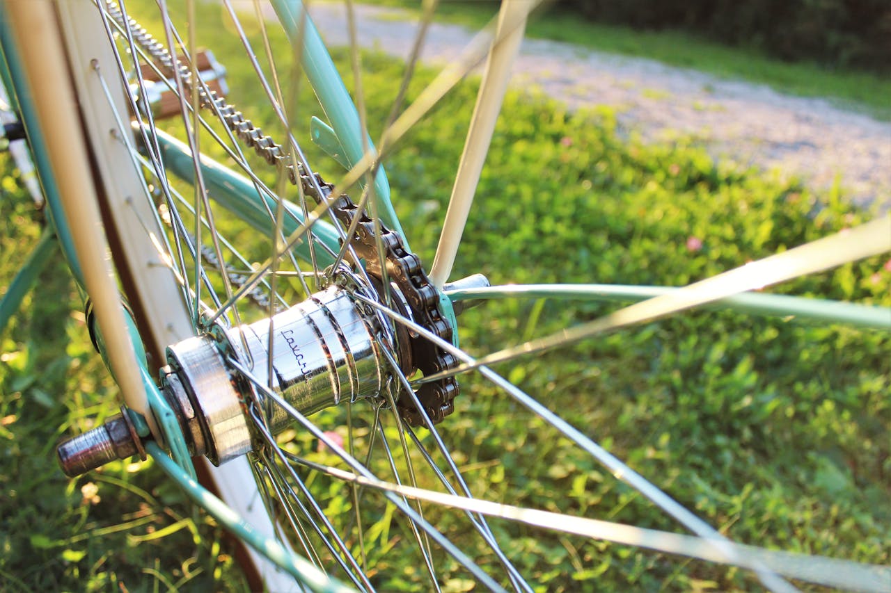 services-01 Detailed close-up of a bicycle wheel hub and spokes shimmering in sunlight.